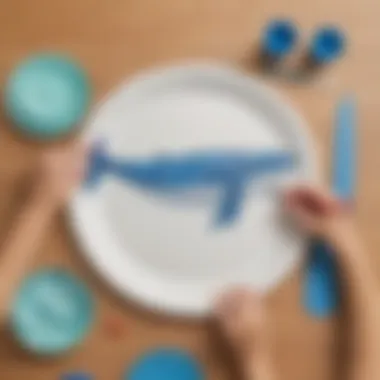 Child creating paper plate whale