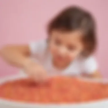 Young child engaged in sensory play activity with colored rice