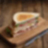 A beautifully styled turkey slice sandwich on a rustic wooden table
